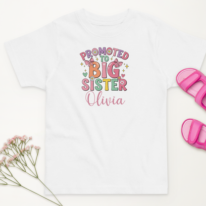 Celebrate your little one’s new role with this personalised “Promoted to Big Sister” t-shirt. Customise it with her name for the perfect sibling announcement or gift!
